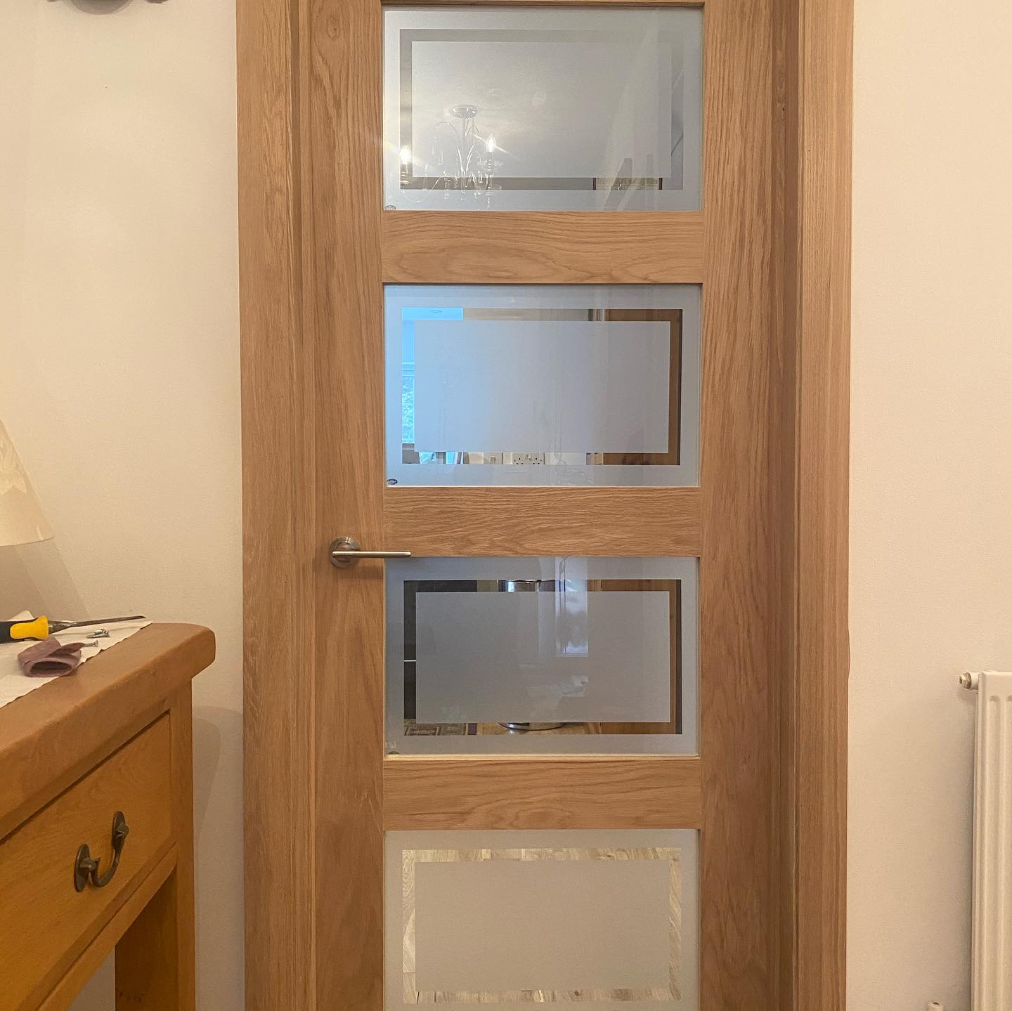 Wooden door with four sections holding frosted windows